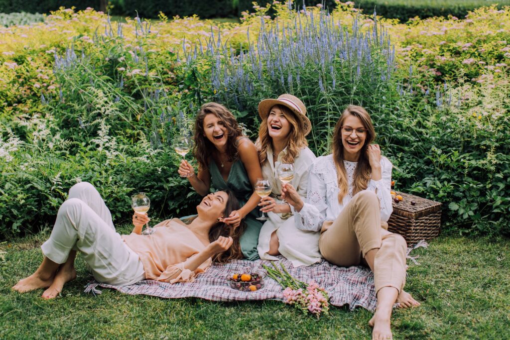 Image of friends having a picnic during a bridesmaid proposal